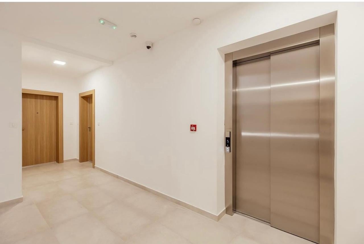 Modern entrance hall with an elevator and bright finishes in a residential complex, Igalo, Herceg Novi, Montenegro.