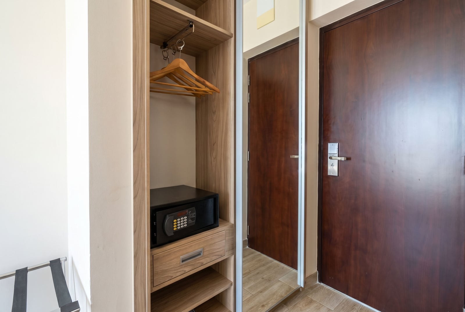 Built-in wardrobe with a safe and mirror in a bedroom of an apartment in Becici, Montenegro. Modern interior with high-quality finishes.