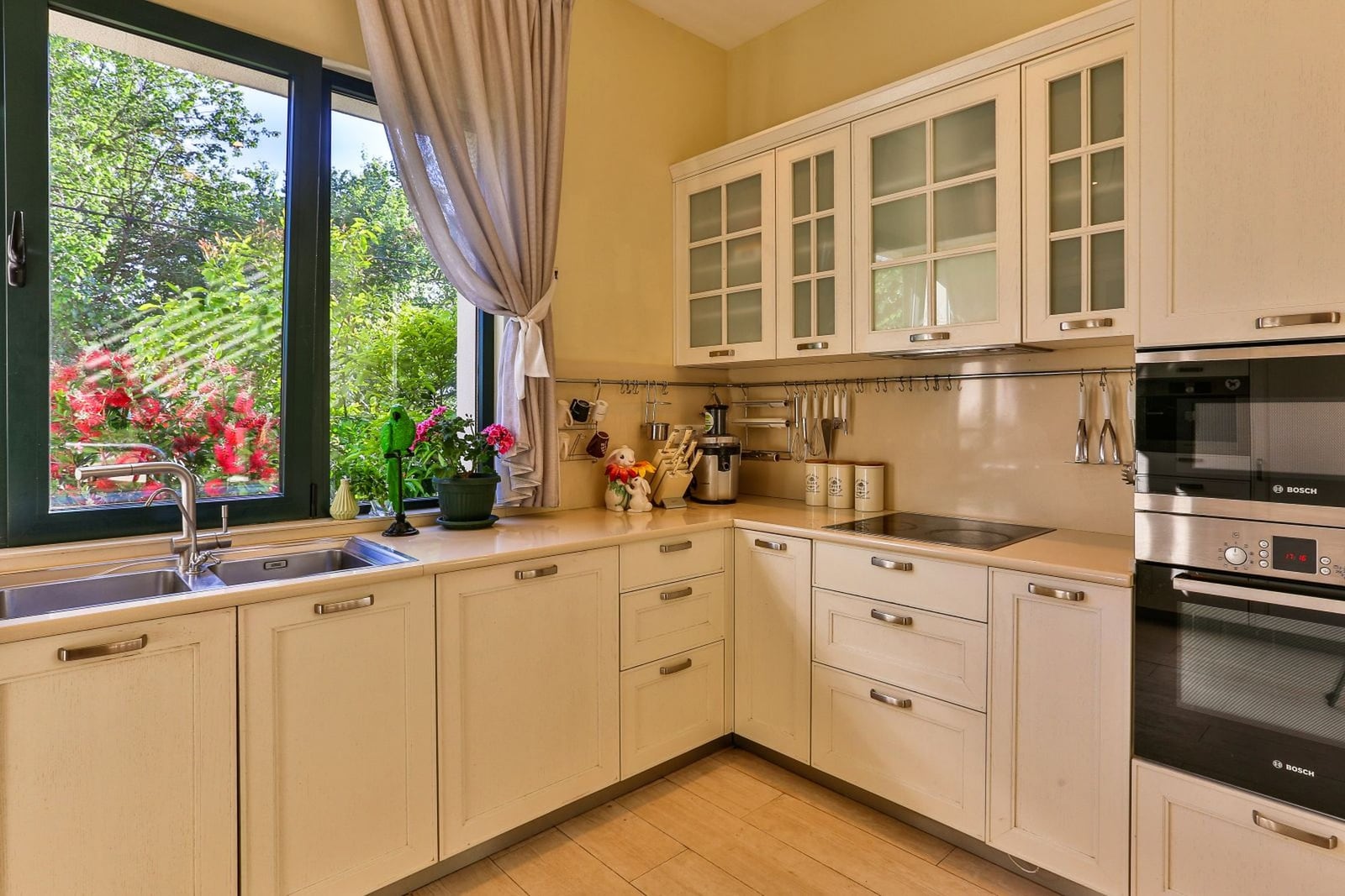 Bright kitchen with Bosch appliances and a garden view in a villa in Tivat, Montenegro. Cozy interior with classic furniture.