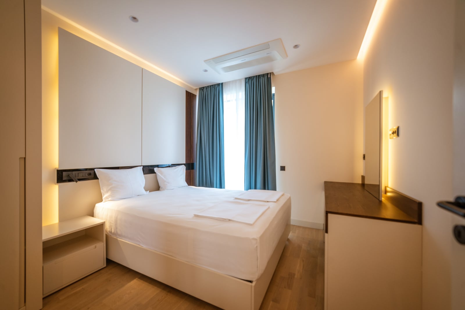 Modern bedroom with a double bed and lighting in an apartment, Bečići, Montenegro.