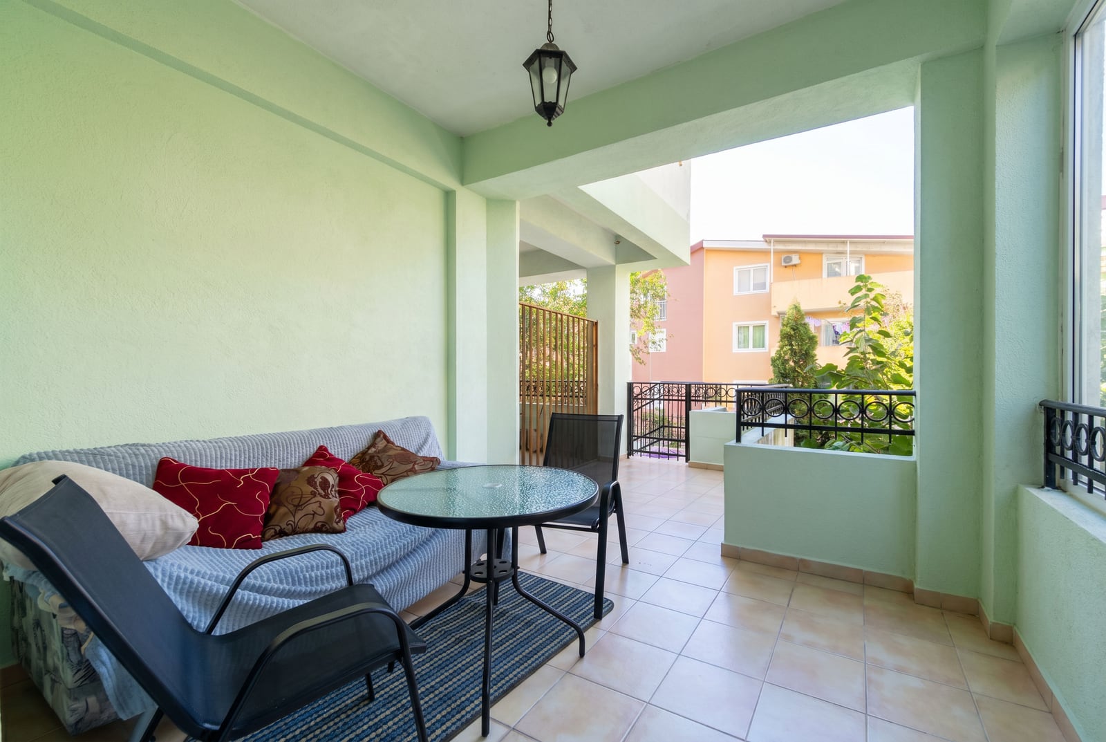 Spacious terrace with furniture and a lounge area in a Budva apartment, Montenegro: view of the city and the residential complex.
