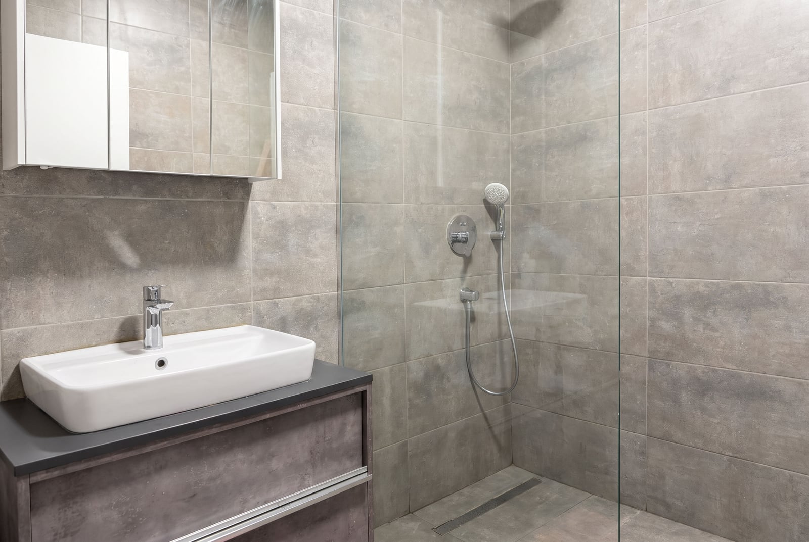 Modern bathroom with a shower area and gray tiles in an apartment, Tivat, Montenegro