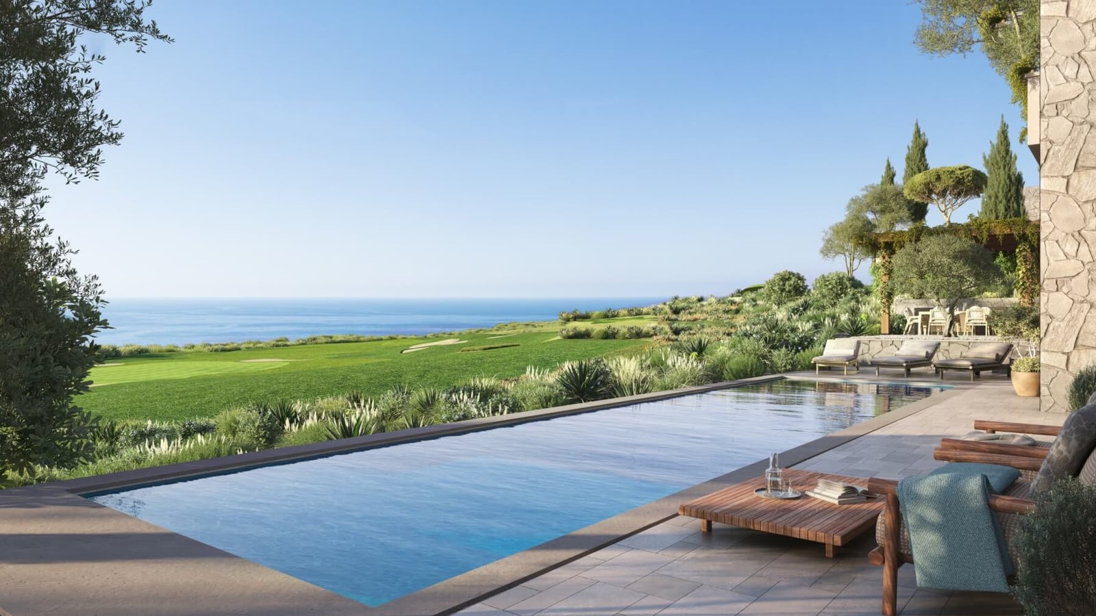 Infinity pool at a villa in Luštica, Montenegro, with panoramic sea views, golf courses, and a terrace with sun loungers.