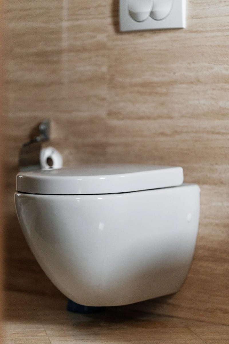 Modern wall-mounted bathroom fixtures in an apartment in Budva, Montenegro, with beige tiled wall finishes.