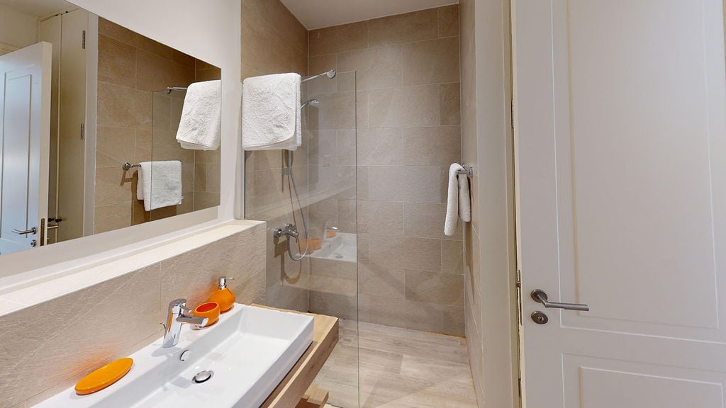 Modern bathroom with a shower cabin and tile finish in an apartment, Luštica, Montenegro.