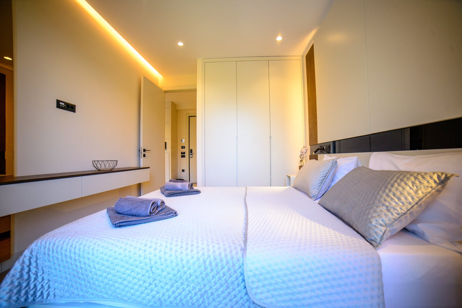 Modern bedroom with a double bed and built-in wardrobe in an apartment, Bečići, Montenegro.