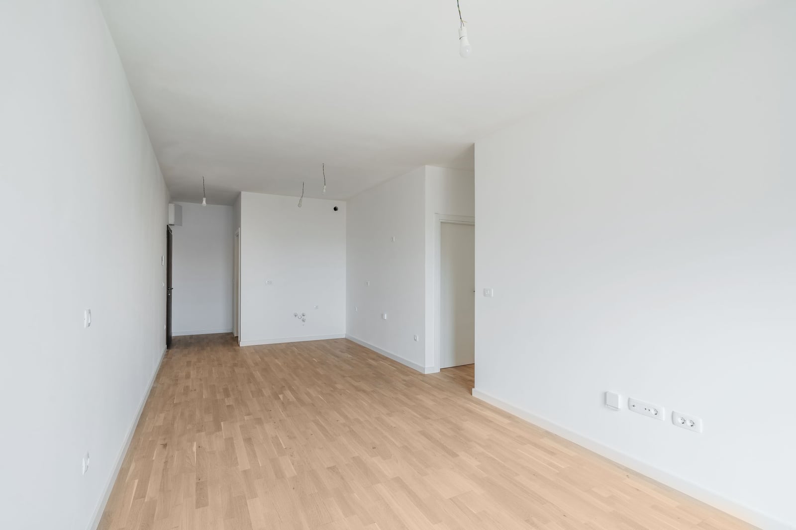 Bright living room with turnkey finishes and parquet flooring in a new residential complex in Budva, Montenegro.