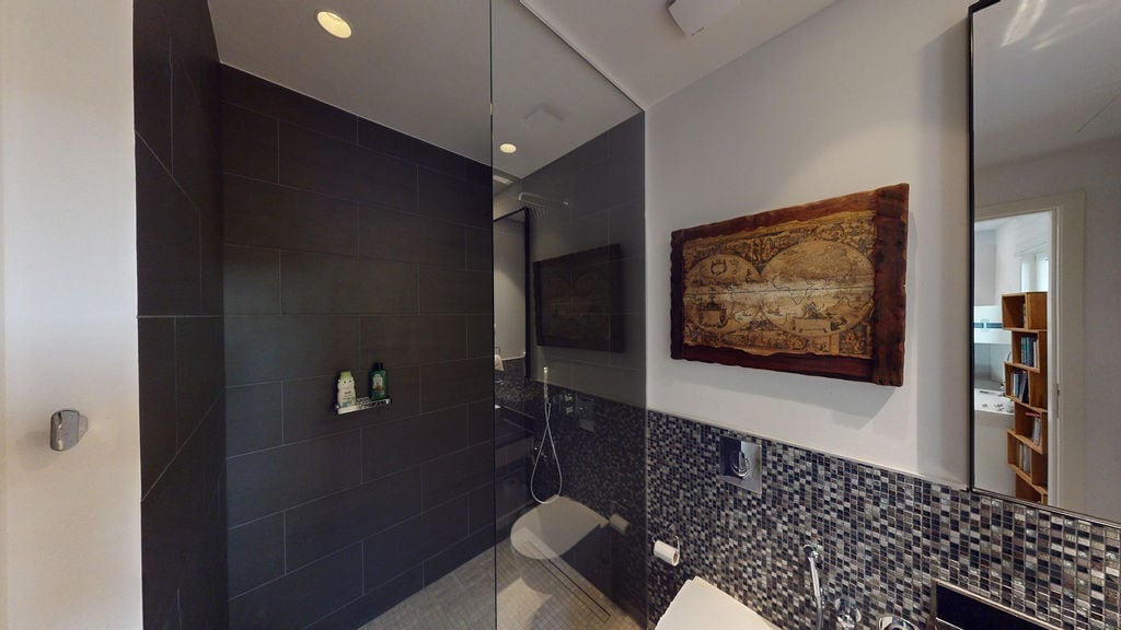 Modern bathroom with a shower cabin in a townhouse, Luštica, Montenegro: stylish tiling and decor.