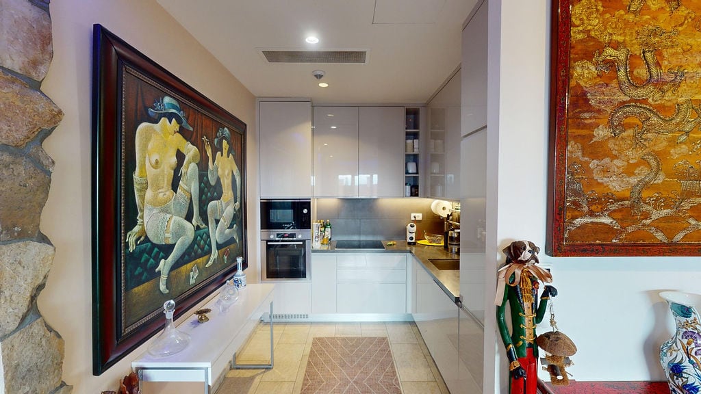 Modern kitchen in a townhouse, Luštica, Montenegro: glossy facades, built-in appliances, and designer decor.