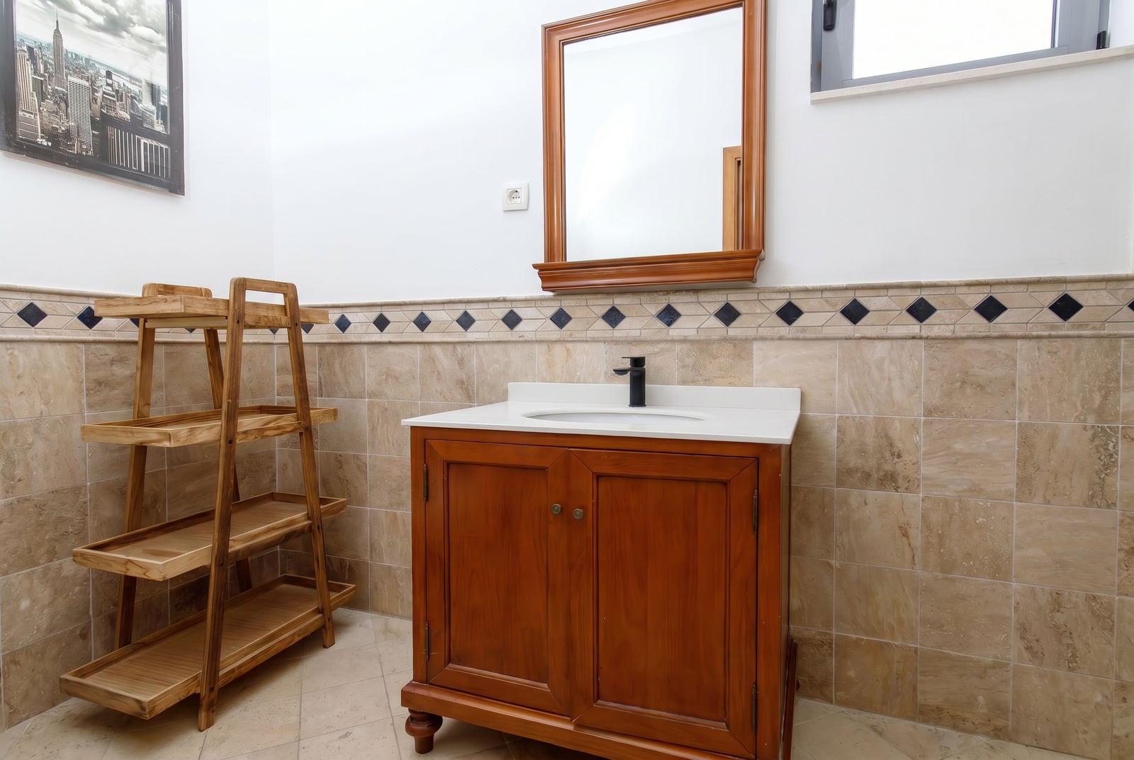 Bathroom in an apartment in Risan, Montenegro: wooden vanity with sink, mirror, and shelving unit in a classic style.