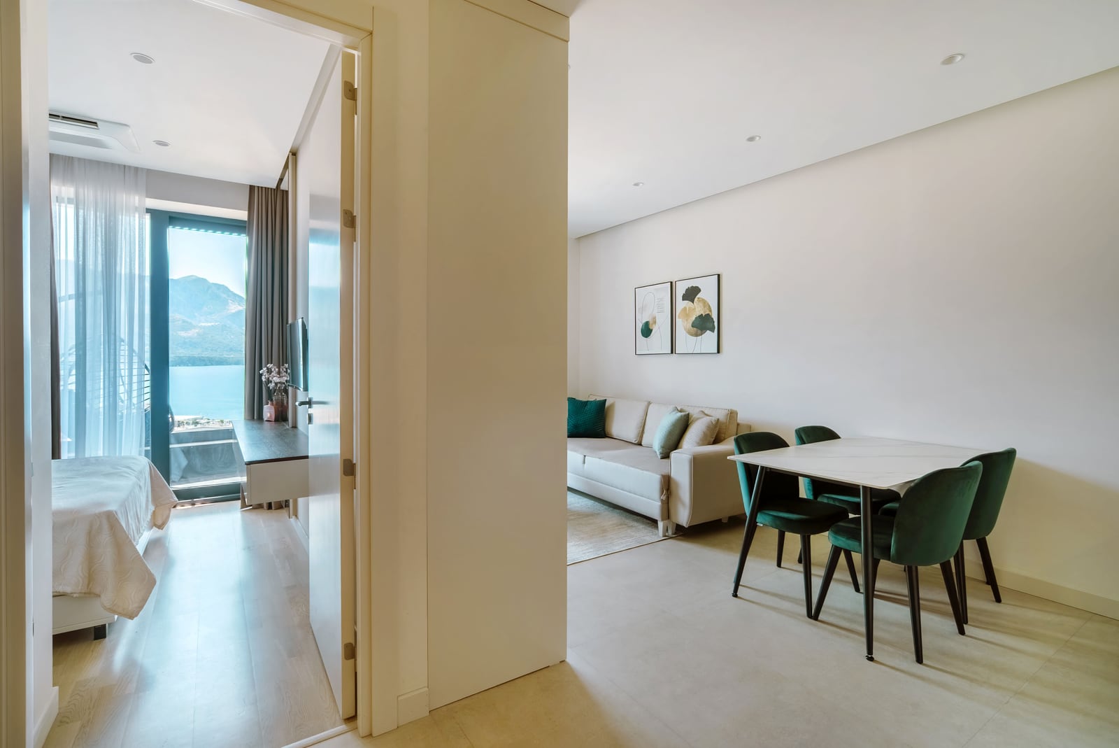 Modern living room with a dining area and sea view in an apartment, Bečići, Montenegro. Bright interior, furniture in a modern style...