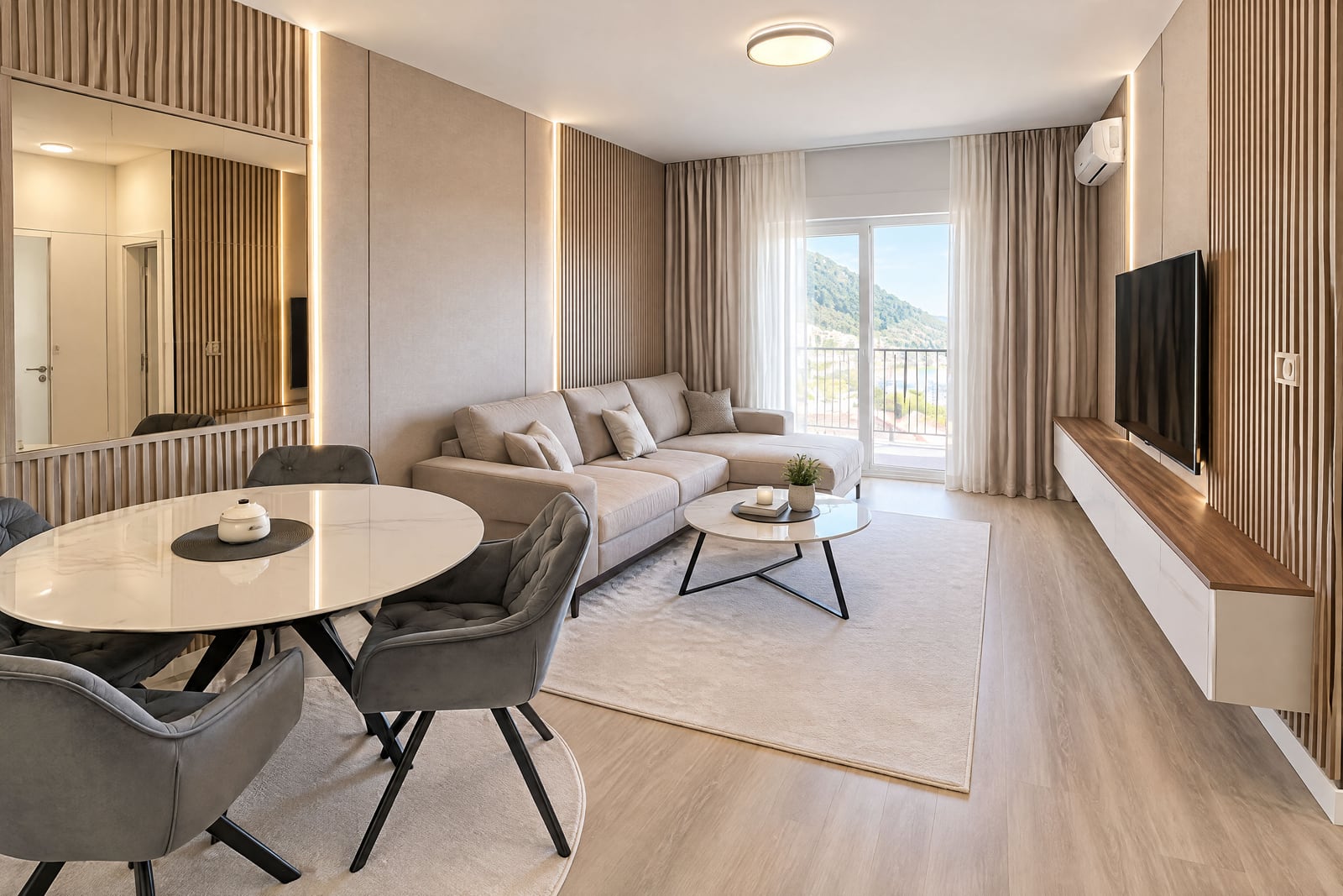 Modern living room featuring a beige sofa, round dining table, wall-mounted TV on wood slats, and balcony access.