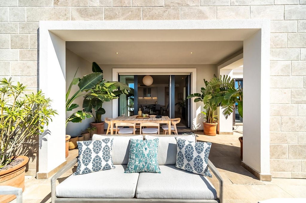 Cozy terrace with a soft sofa and dining area in a luxury residential complex, Luštica, Montenegro.
