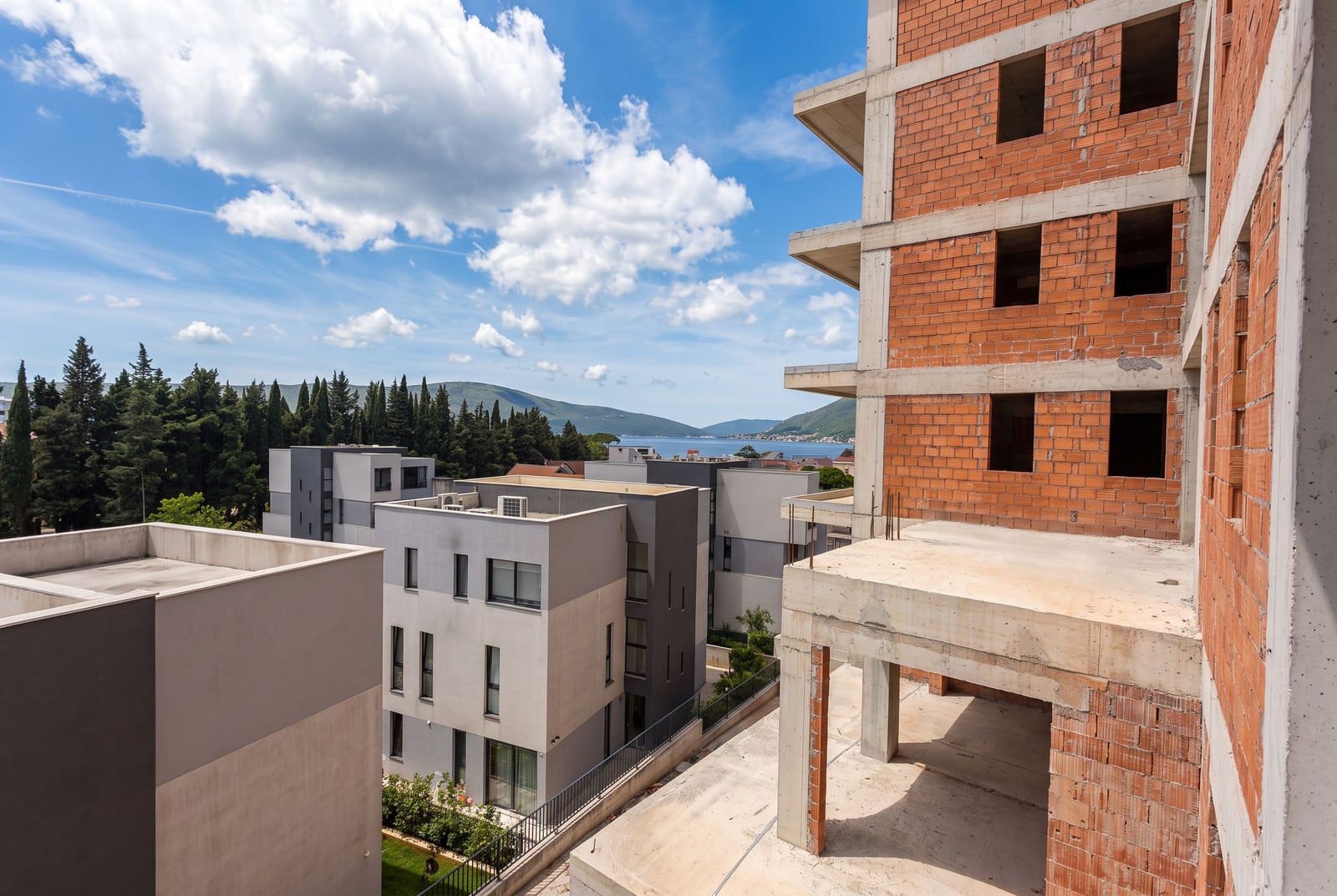 Residential building under construction, made of brick and concrete, with a sea view in Tivat, Montenegro.