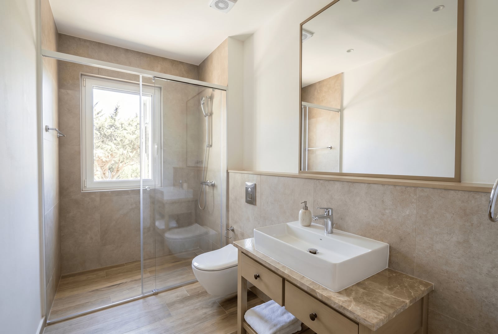 Modern bathroom with a shower cabin and stone countertop in an apartment, Luštica, Montenegro.