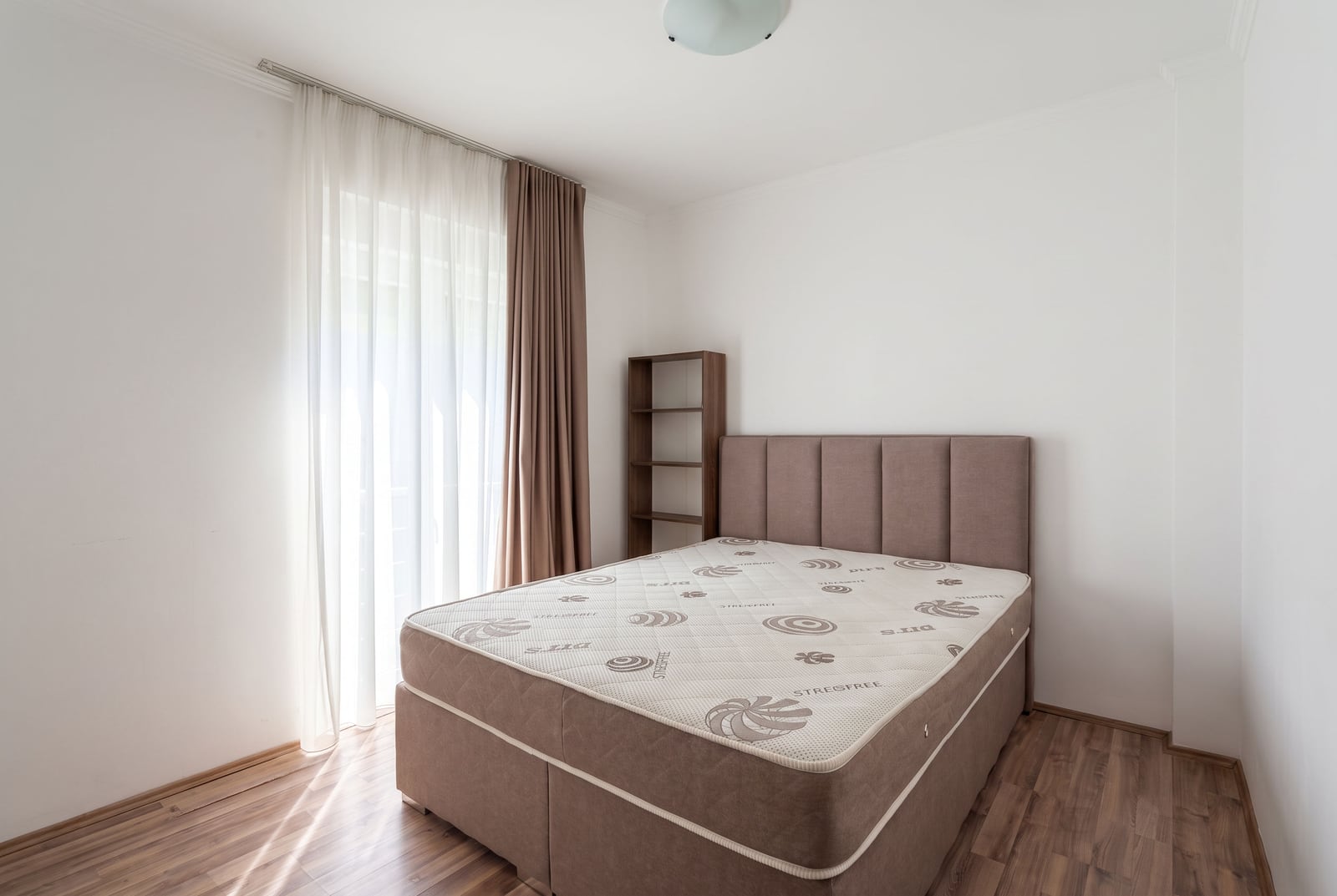Bright bedroom with a double bed and balcony access in an apartment in Tivat, Montenegro