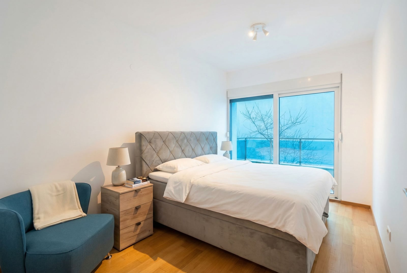 Modern bedroom with a double bed and sea view in an apartment, Becici, Montenegro.