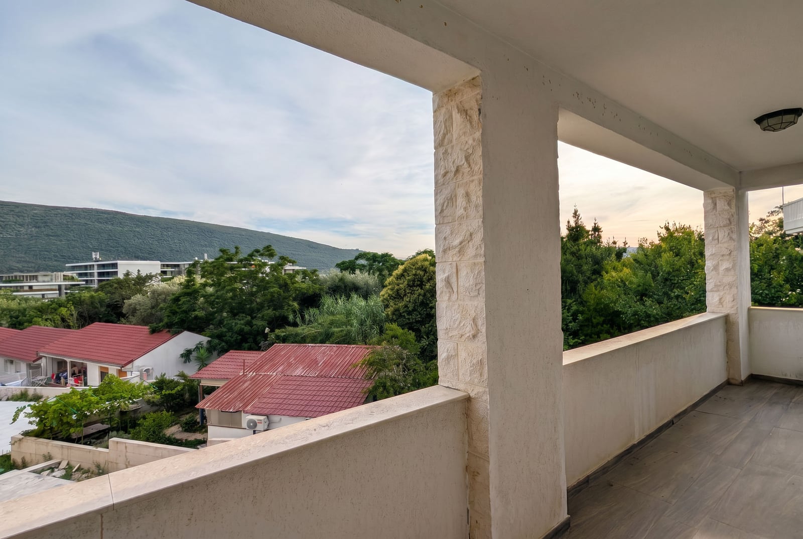 Spacious stone-finished balcony with mountain and greenery views in an apartment, Kumbor, Montenegro
