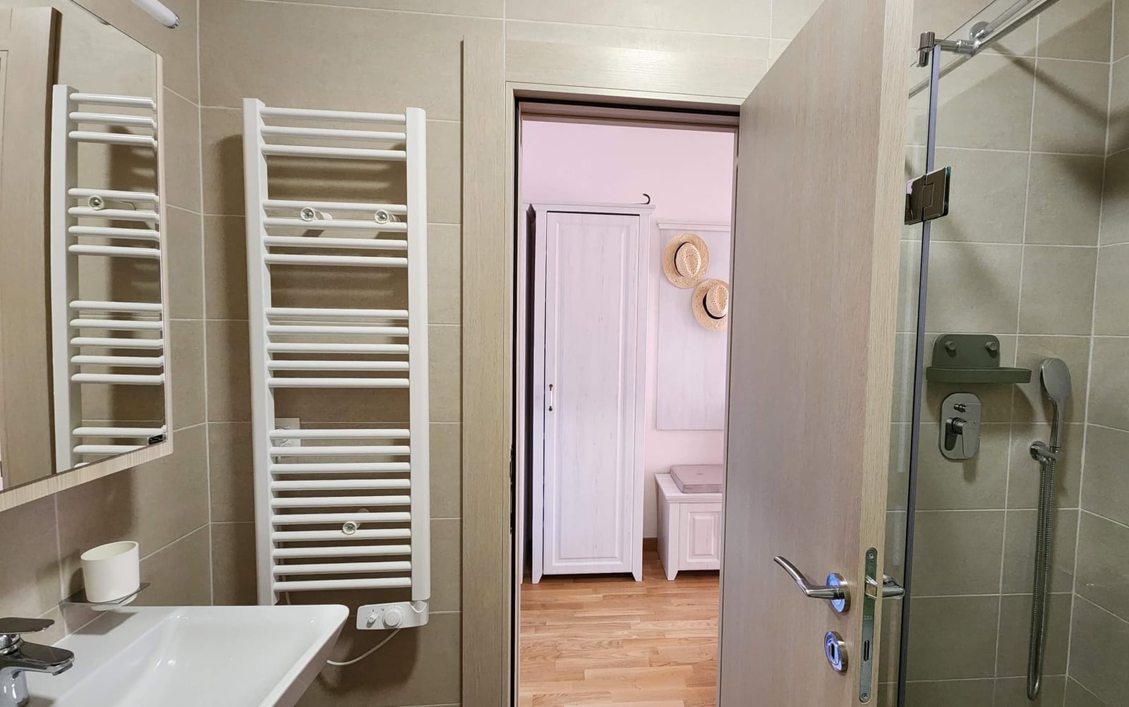 Modern bathroom with a walk-in shower and a heated towel rail in an apartment in Budva, Montenegro.