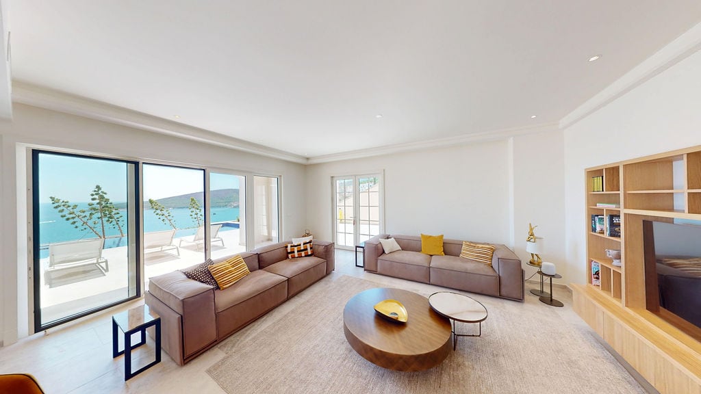 Modern living room in a villa in Luštica, Montenegro: soft furniture, wooden finishes, and panoramic sea view.