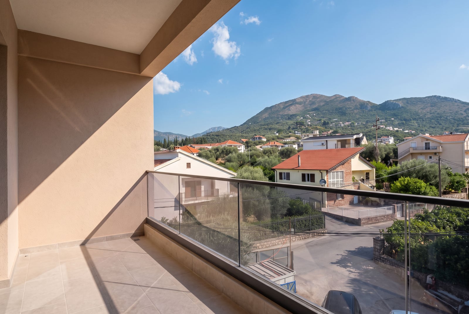 Panoramic balcony view of the apartment overlooking the mountains and city in Bar, Montenegro.
