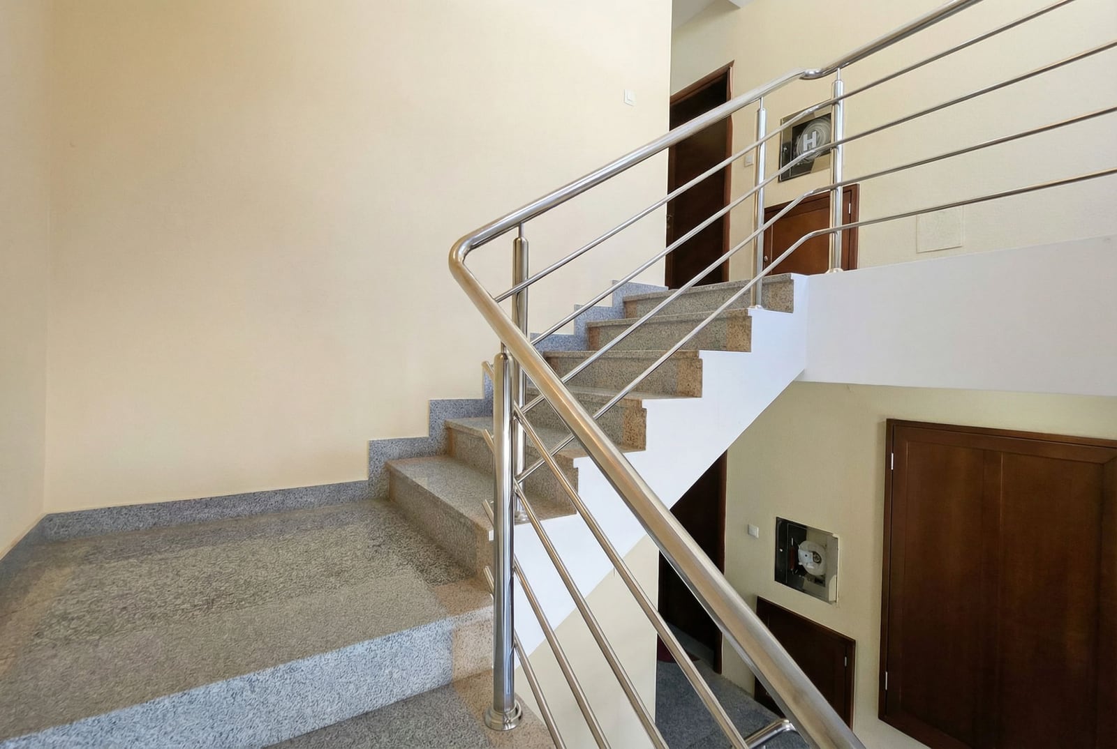 Staircase with granite steps and metal railings in a residential building in Tivat, Montenegro.