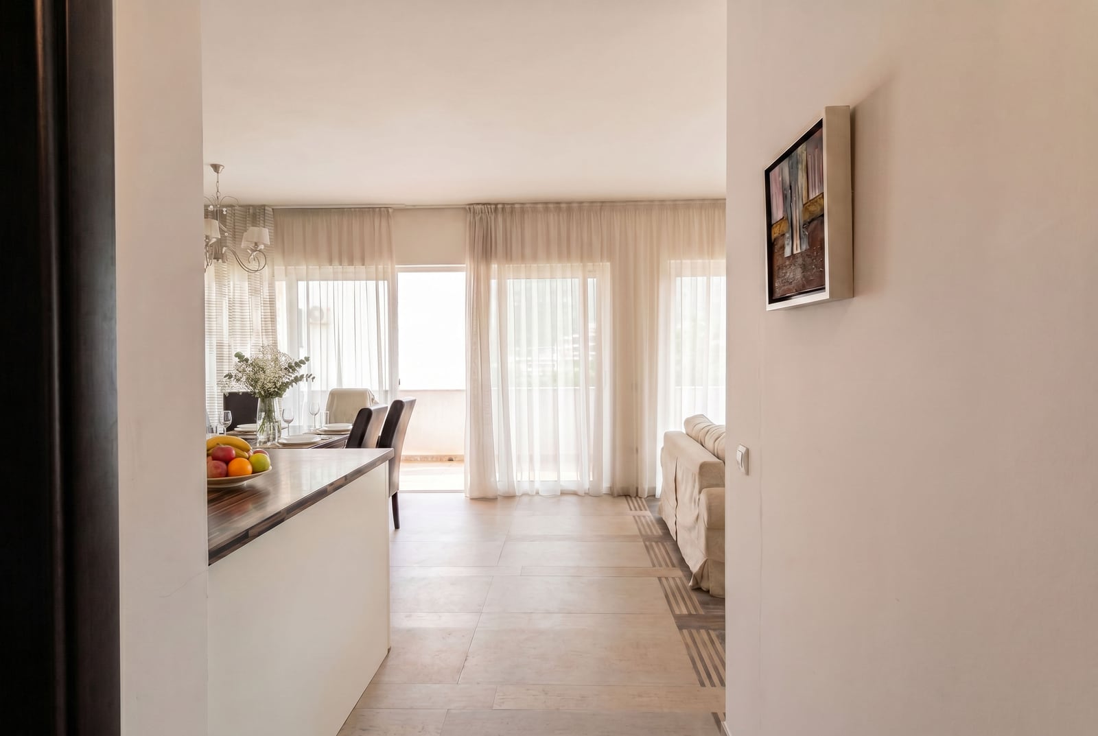 Bright living room with a dining area and terrace access in an apartment, Kumbor, Montenegro. Modern interior.