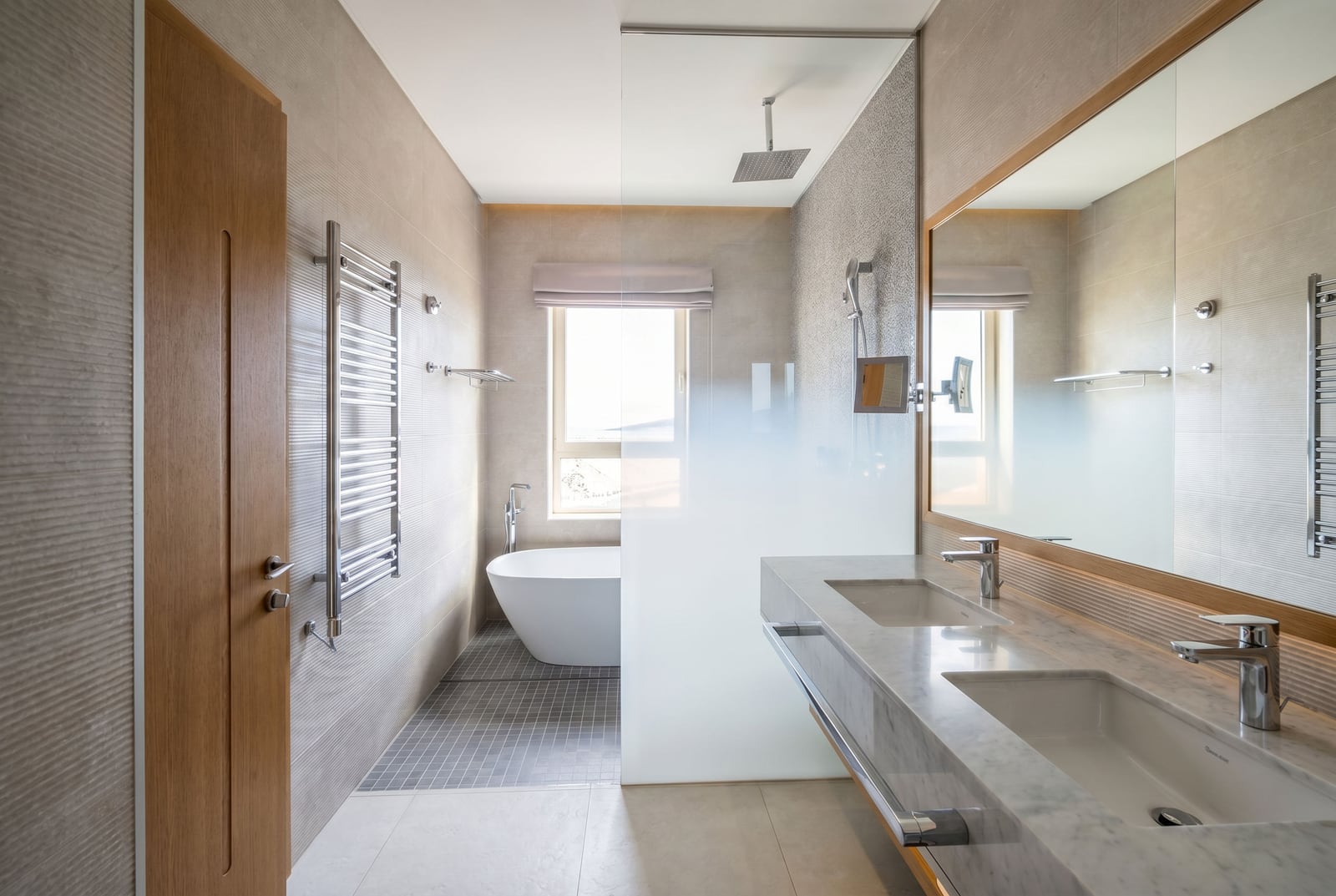 Modern bathroom with a freestanding bathtub and double vanity in a Lustica Bay apartment, Montenegro.