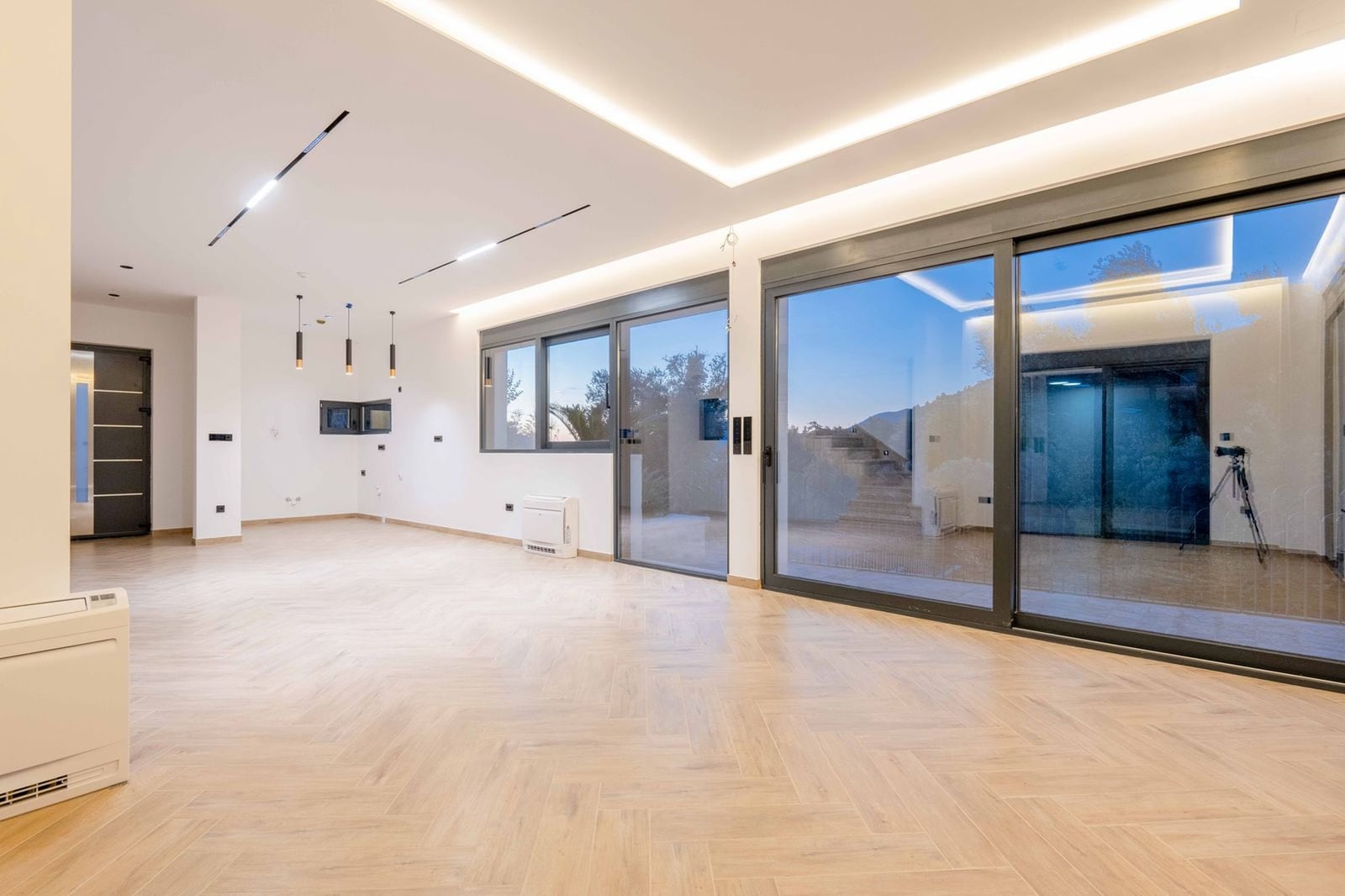 Spacious living room with panoramic windows and light parquet flooring in a modern villa, Kamenovo, Montenegro.