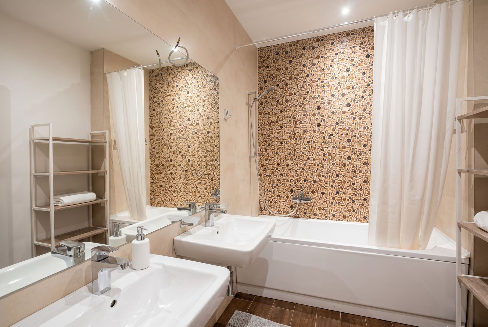 Modern bathroom in a Budva apartment, Montenegro: white sanitary ware, mosaic tiles, and open shelving.