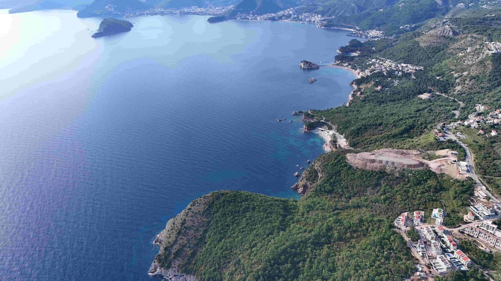 Aerial panoramic view of the coast and sea in the Reževići area, Montenegro, near the land plot.
