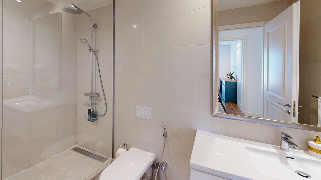 Modern bathroom with a shower cabin and light finishes in a residential complex, Luštica, Montenegro