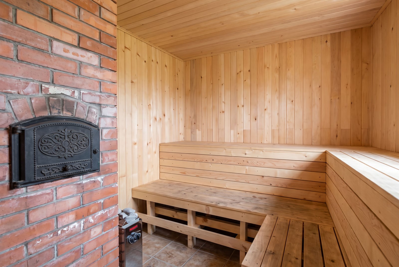 Wooden finish and brick stove in the home sauna of a house in Tivat, Montenegro.