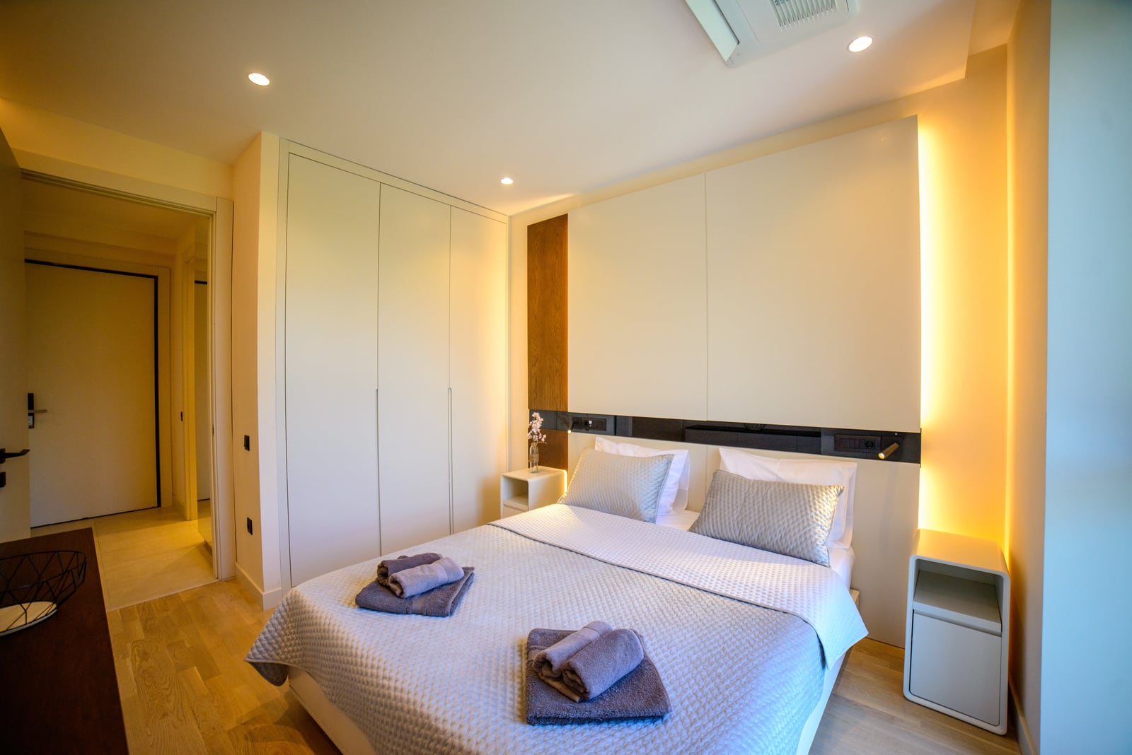 Modern bedroom with a double bed and built-in wardrobe in an apartment, Bečići, Montenegro.