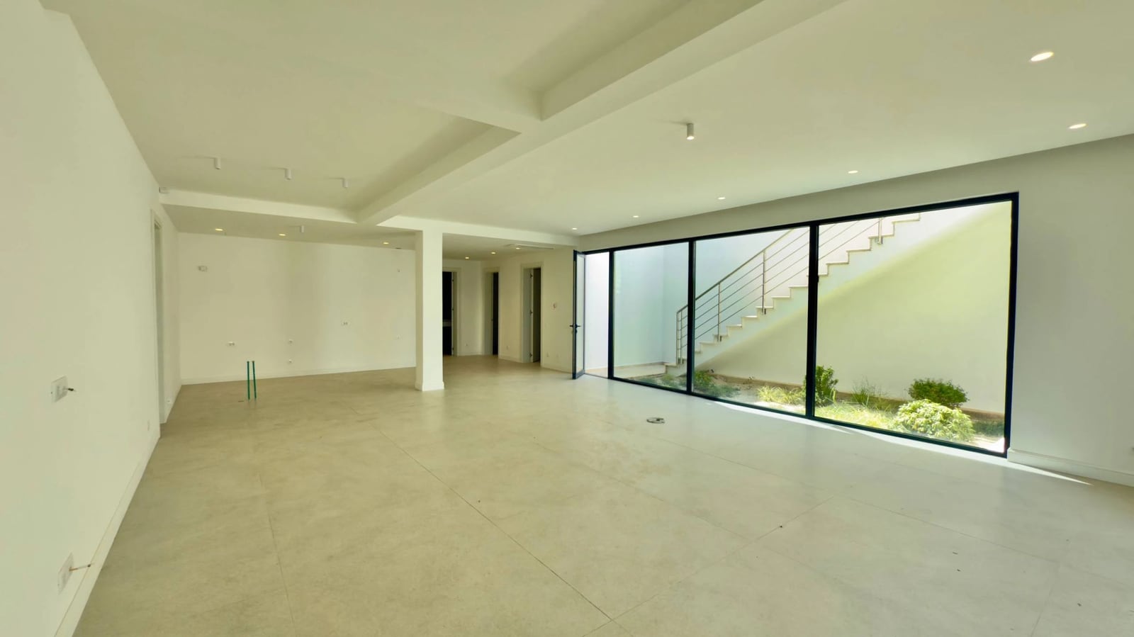 Spacious living room with panoramic windows and access to the terrace in a modern villa, Krašići, Montenegro.