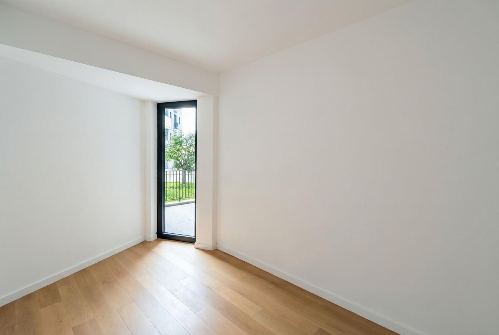 Bright empty living room with parquet flooring and access to the terrace in a new apartment, Becici, Montenegro.