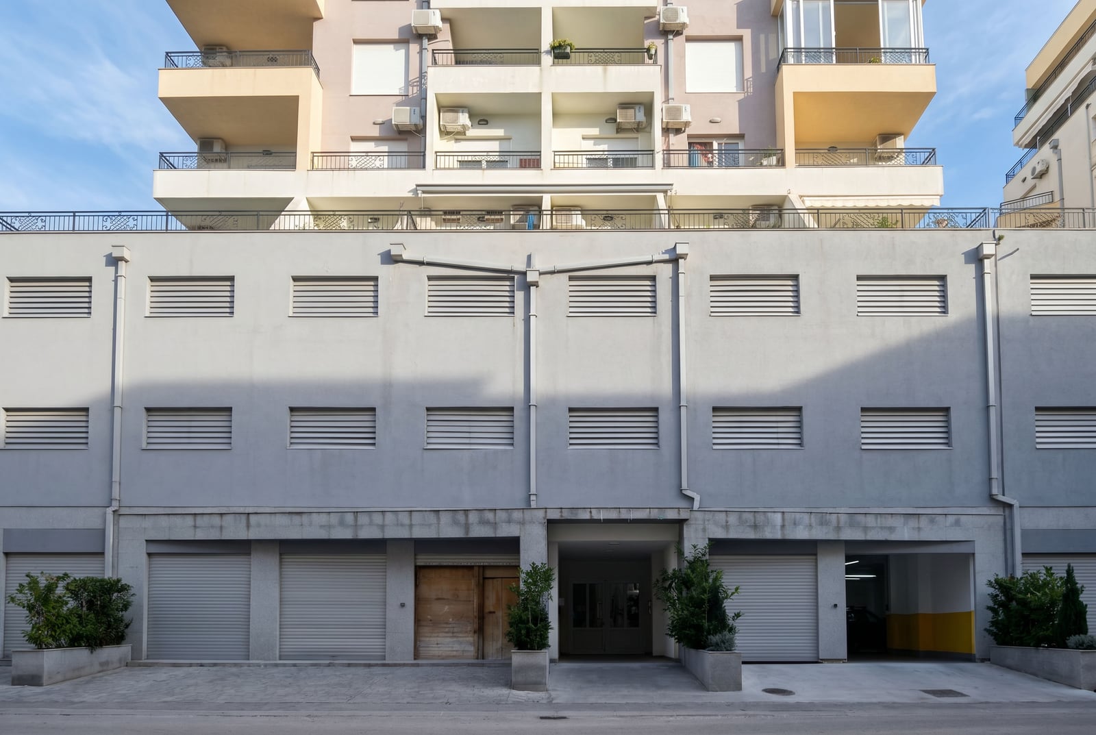 Facade of a modern apartment building with garages and balconies in Budva, Montenegro