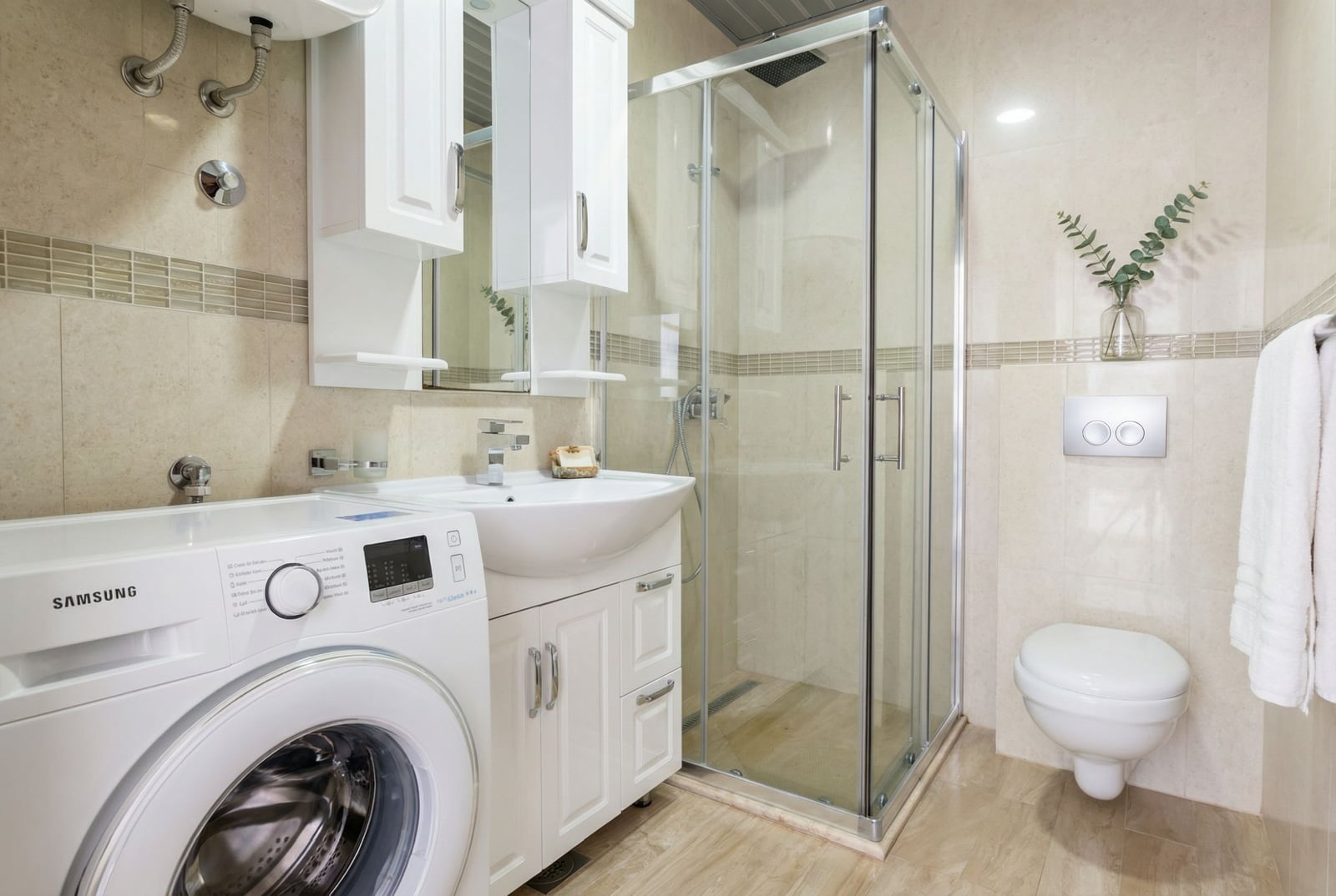 Modern bathroom with a shower cabin and washing machine in an apartment, Tivat, Montenegro.
