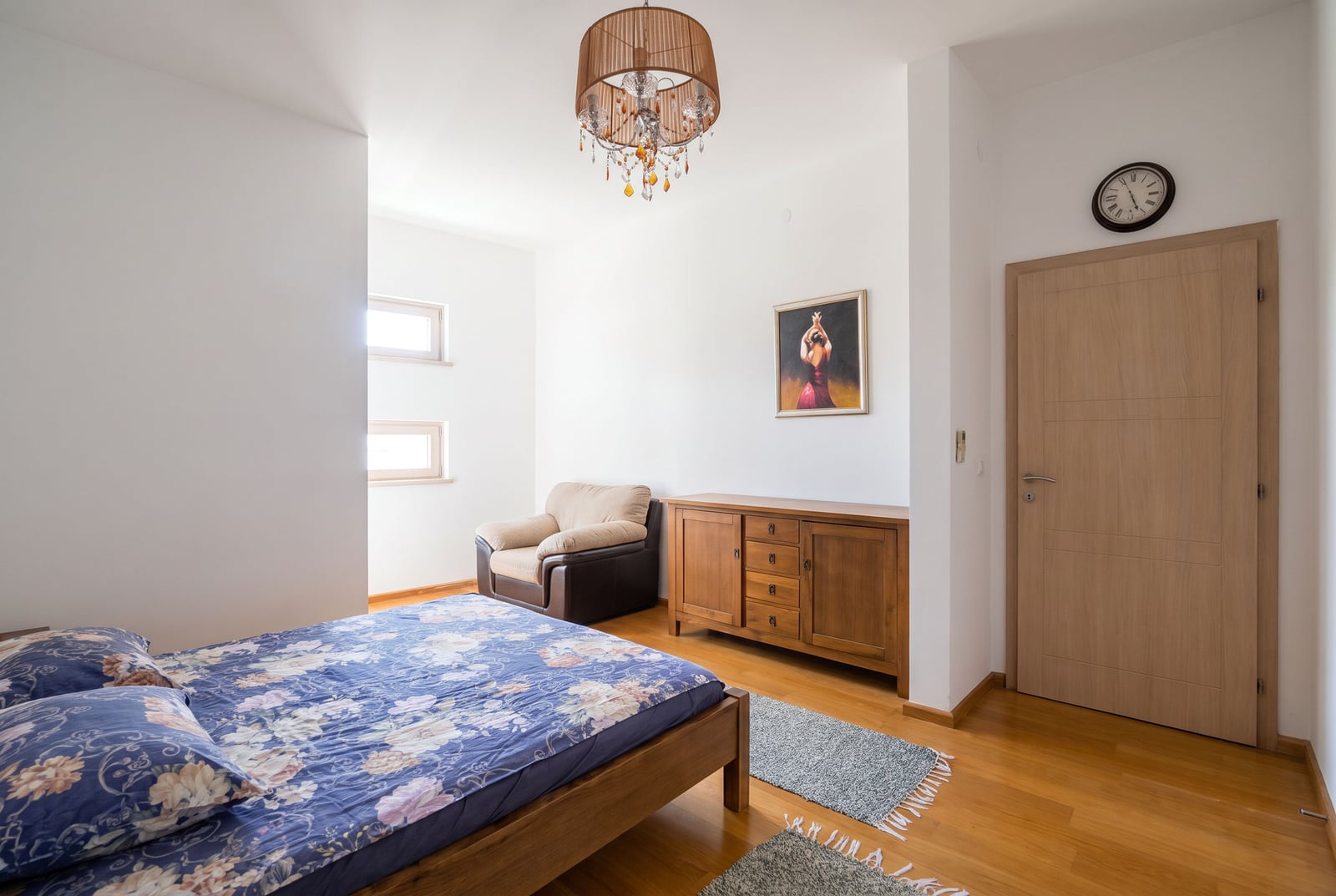 Bright bedroom with wooden furniture and a double bed in an apartment in Bečići, Montenegro.