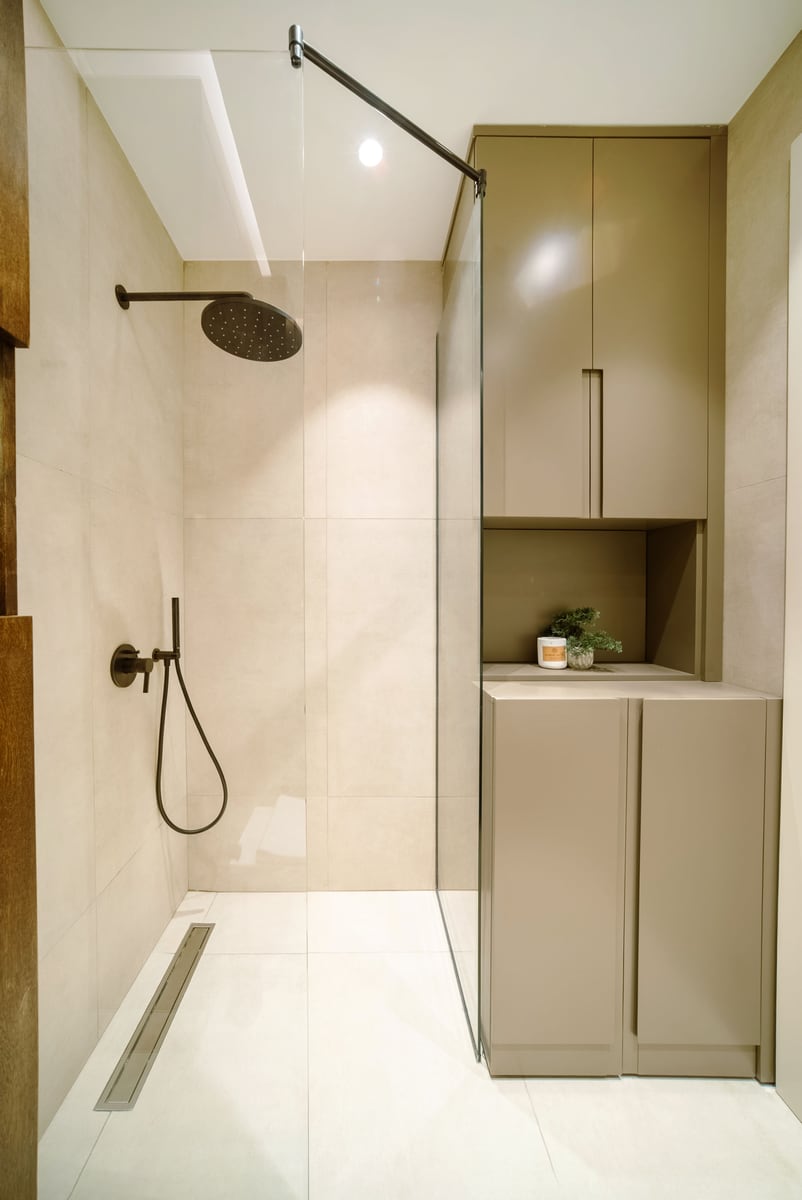 Modern shower cabin with a rain shower in an apartment, Bečići, Montenegro: stylish finishes and built-in furniture.