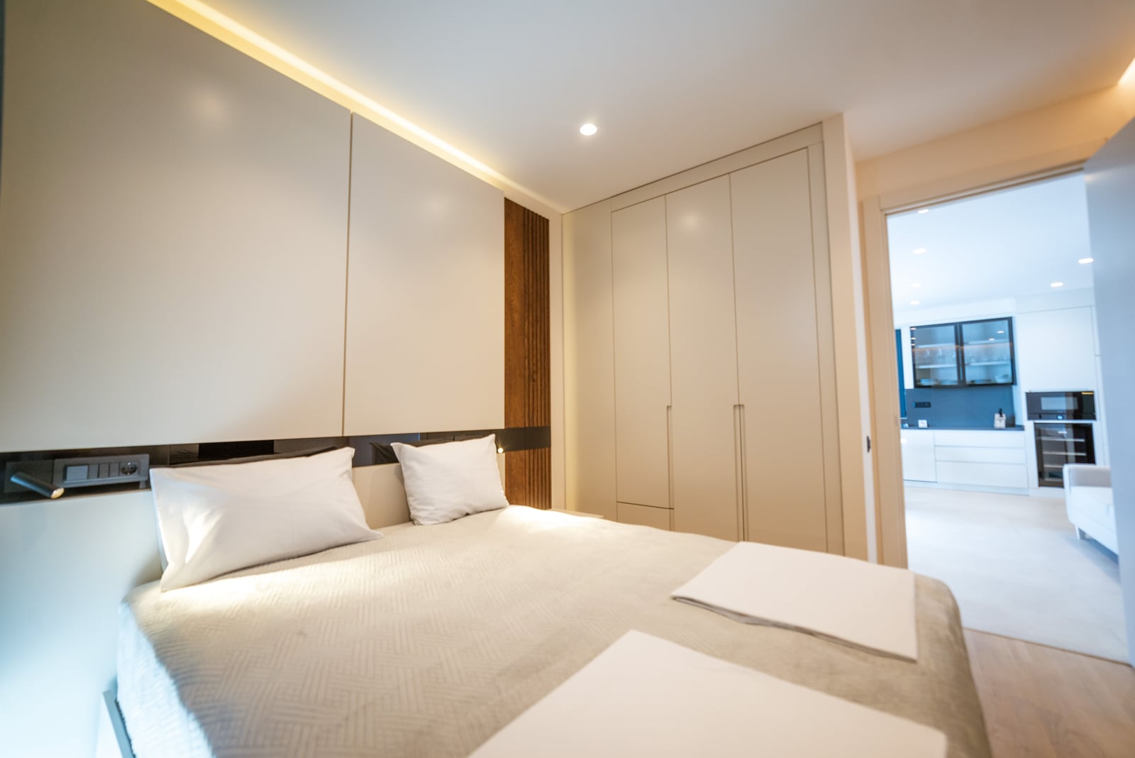 Modern bedroom with a double bed and built-in wardrobe in an apartment, Bečići, Montenegro.