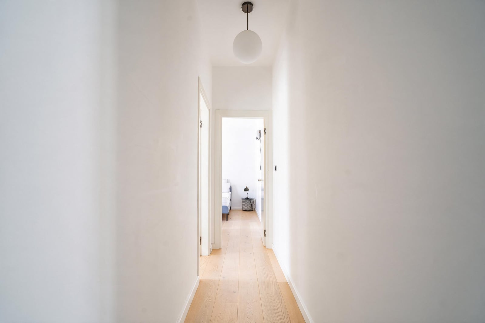 Bright hallway with white walls and wooden floor in an apartment in Tivat, Montenegro