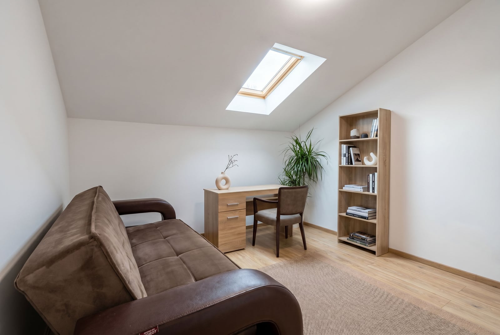 Cozy living room with a skylight, sofa, and workspace in an apartment, Budva, Montenegro.