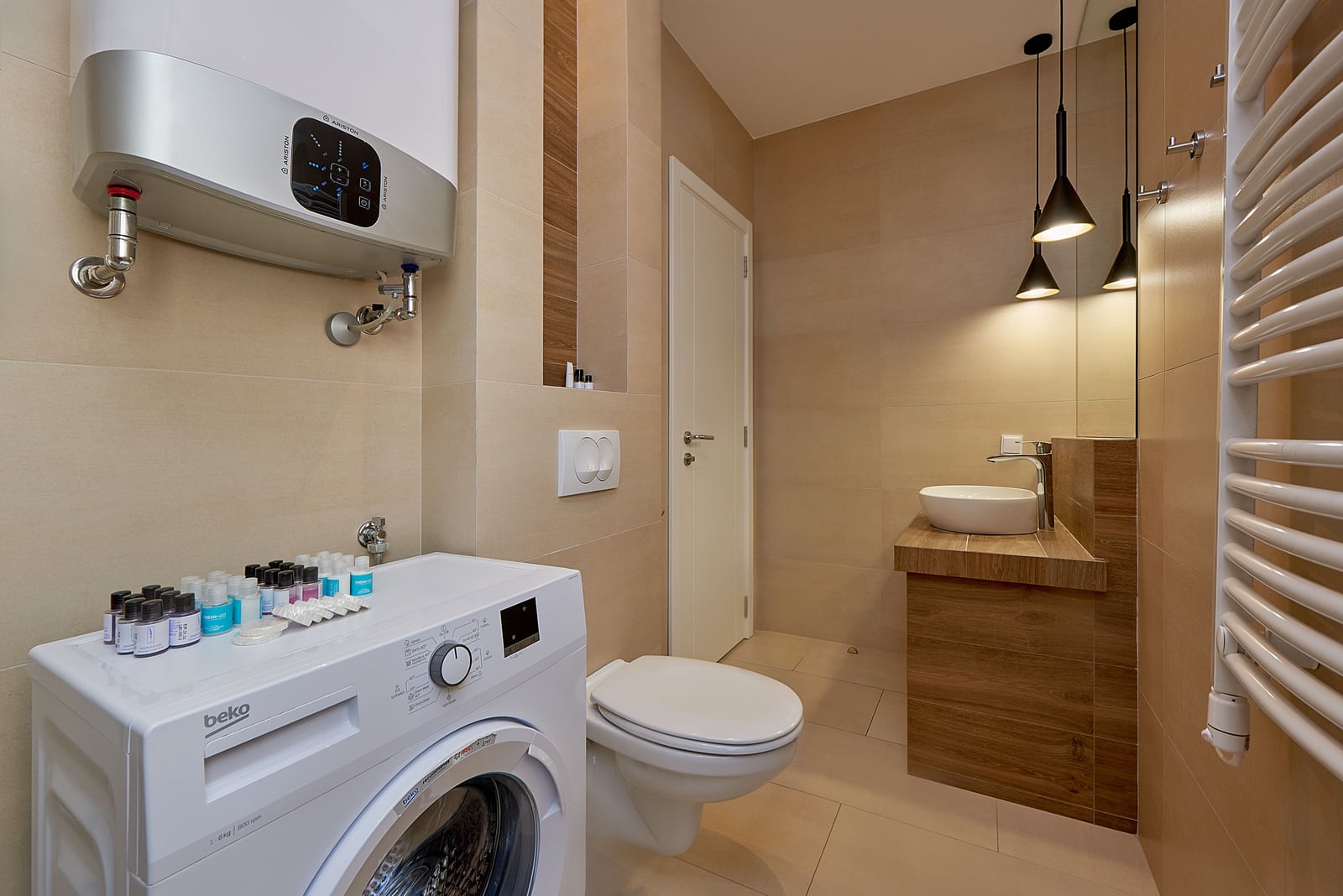 Modern bathroom in an apartment in Bečići, Montenegro: Beko washing machine, Ariston water heater, and vessel sink.