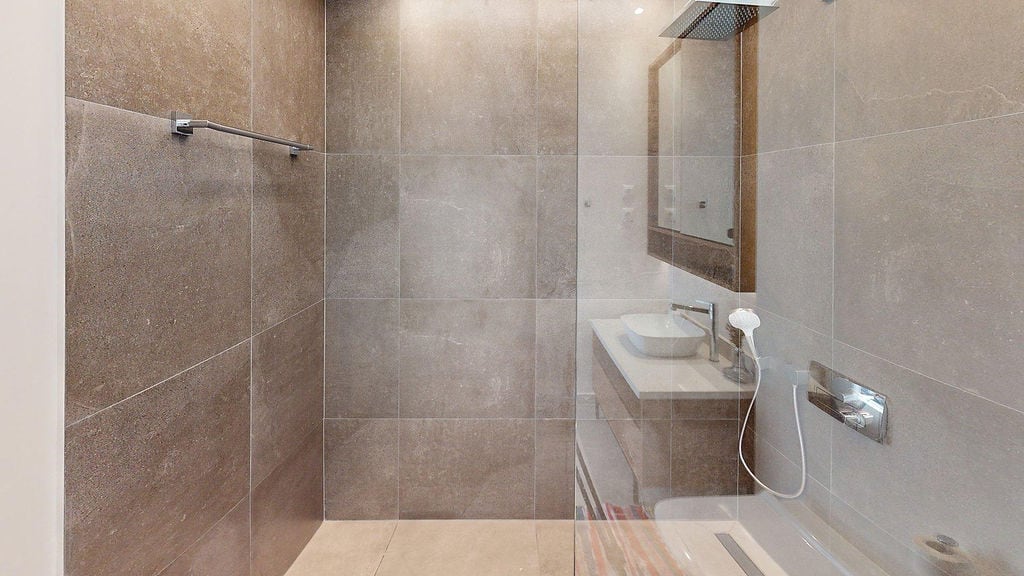 Modern bathroom with a shower cabin and porcelain tile finish in an apartment, Luštica, Montenegro.