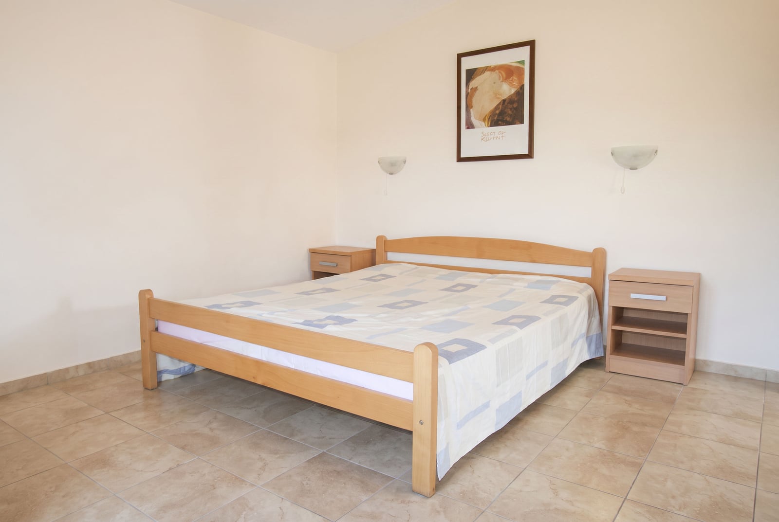 Bright bedroom with a wooden bed and nightstands in a house in Tivat, Montenegro