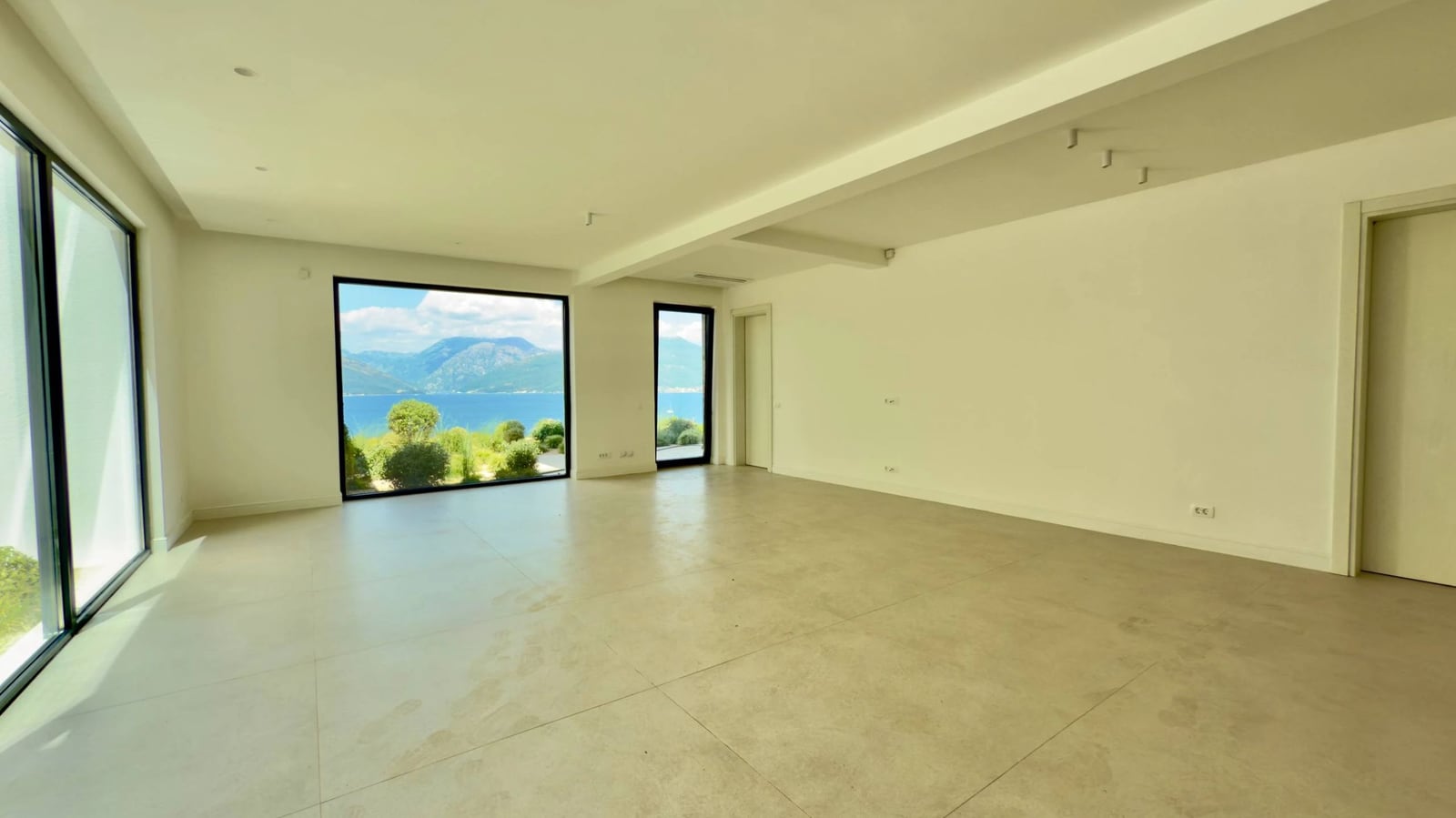 Spacious living room with panoramic windows and sea view in an exclusive villa, Krašići, Montenegro.
