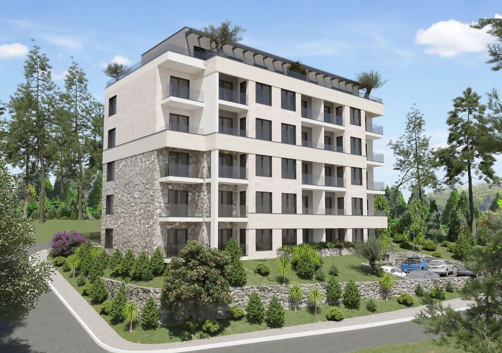 Modern residential complex in Budva, Montenegro: stone-clad facade, panoramic windows, and terraces surrounded by greenery.