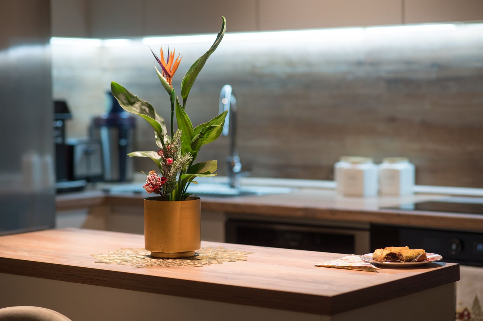 Modern kitchen in an apartment in Tivat, Montenegro: wooden countertop, stylish decor, and built-in appliances.