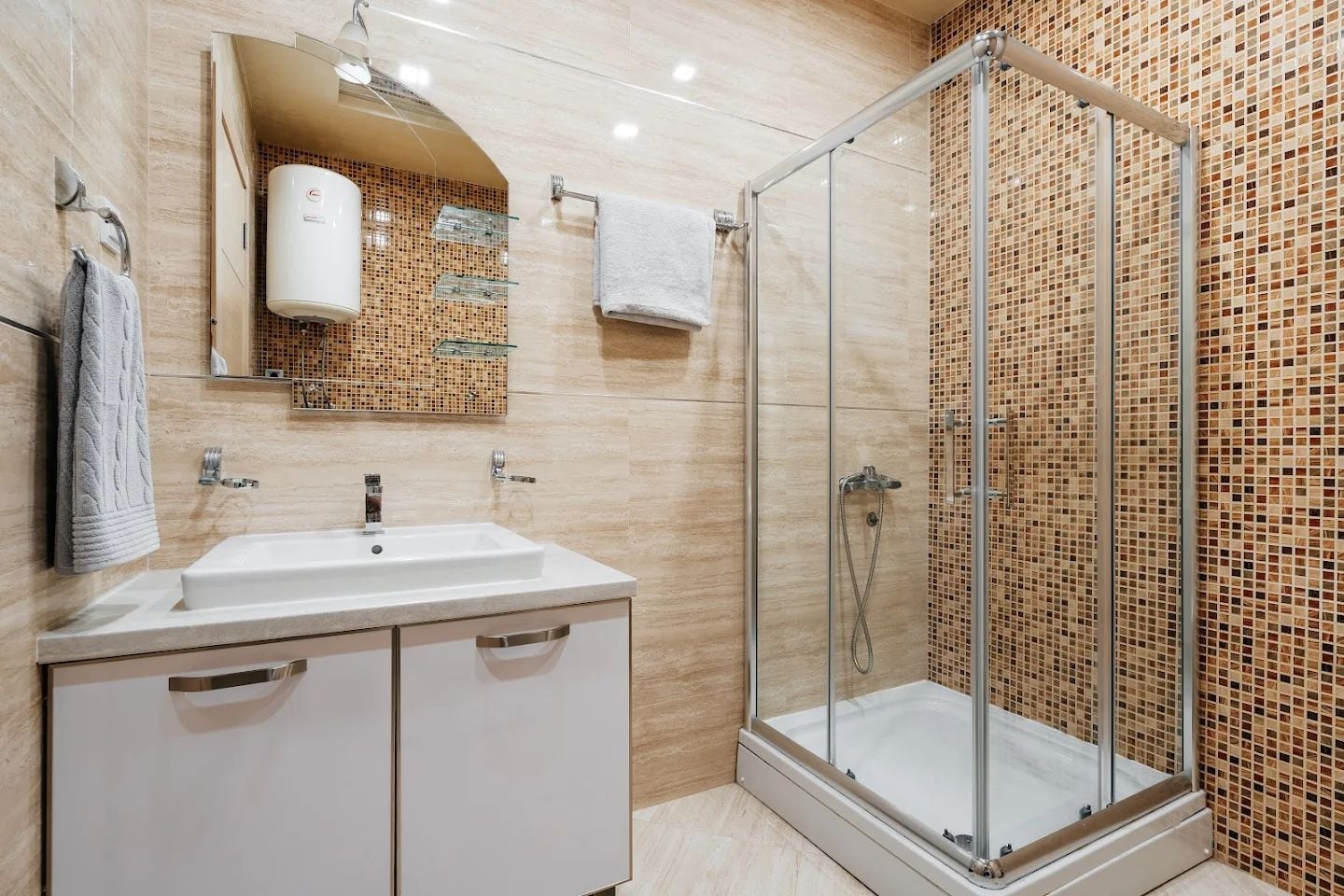Modern bathroom with a shower cabin and a white vanity in an apartment, Budva, Montenegro.